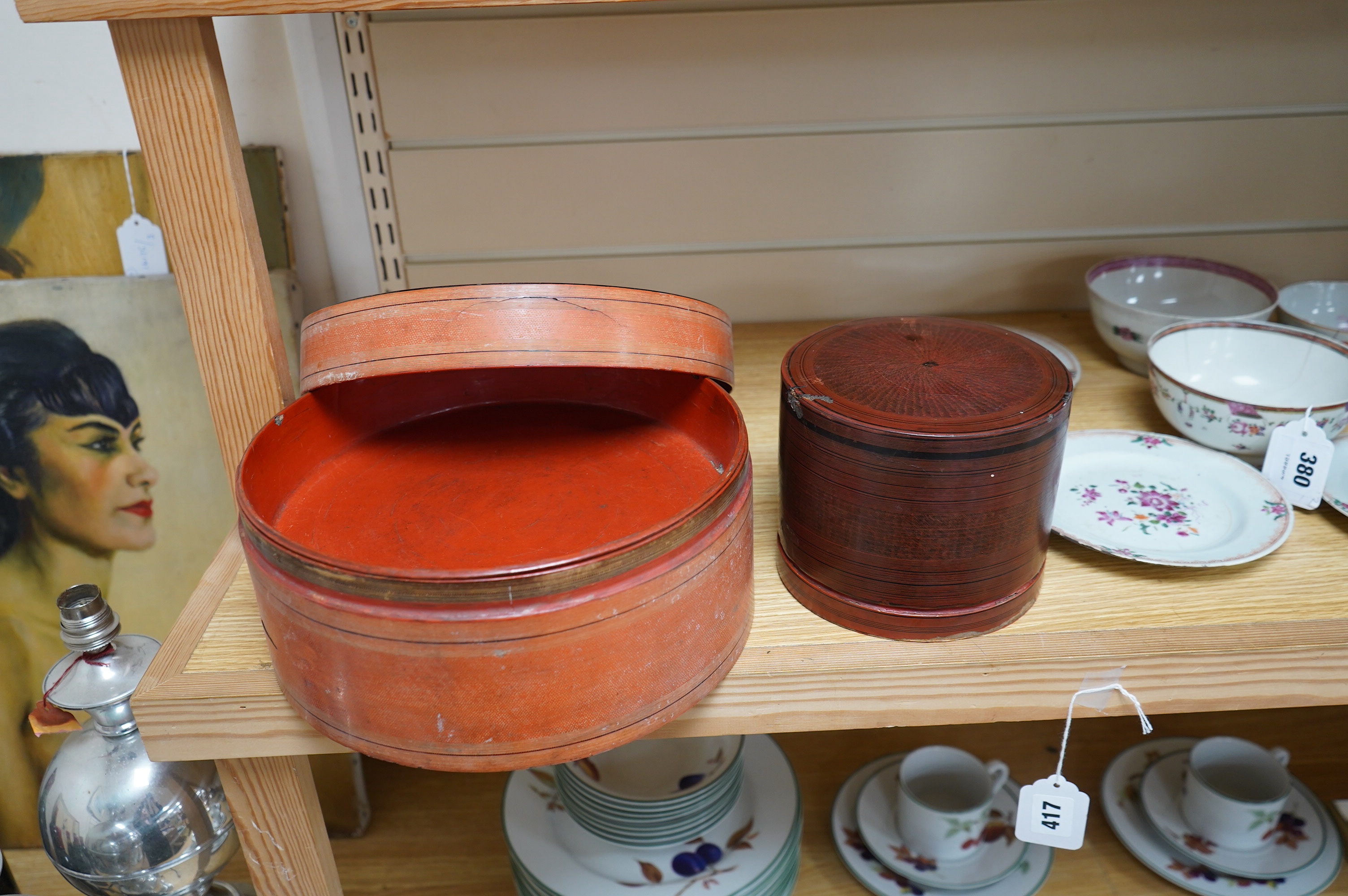 Two 19th century Burmese lacquered cylindrical boxes, largest 27cm in diameter. Condition - poor